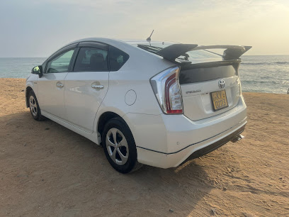 White Toyota Prius on the beach at sunset - SMA taxi fleet